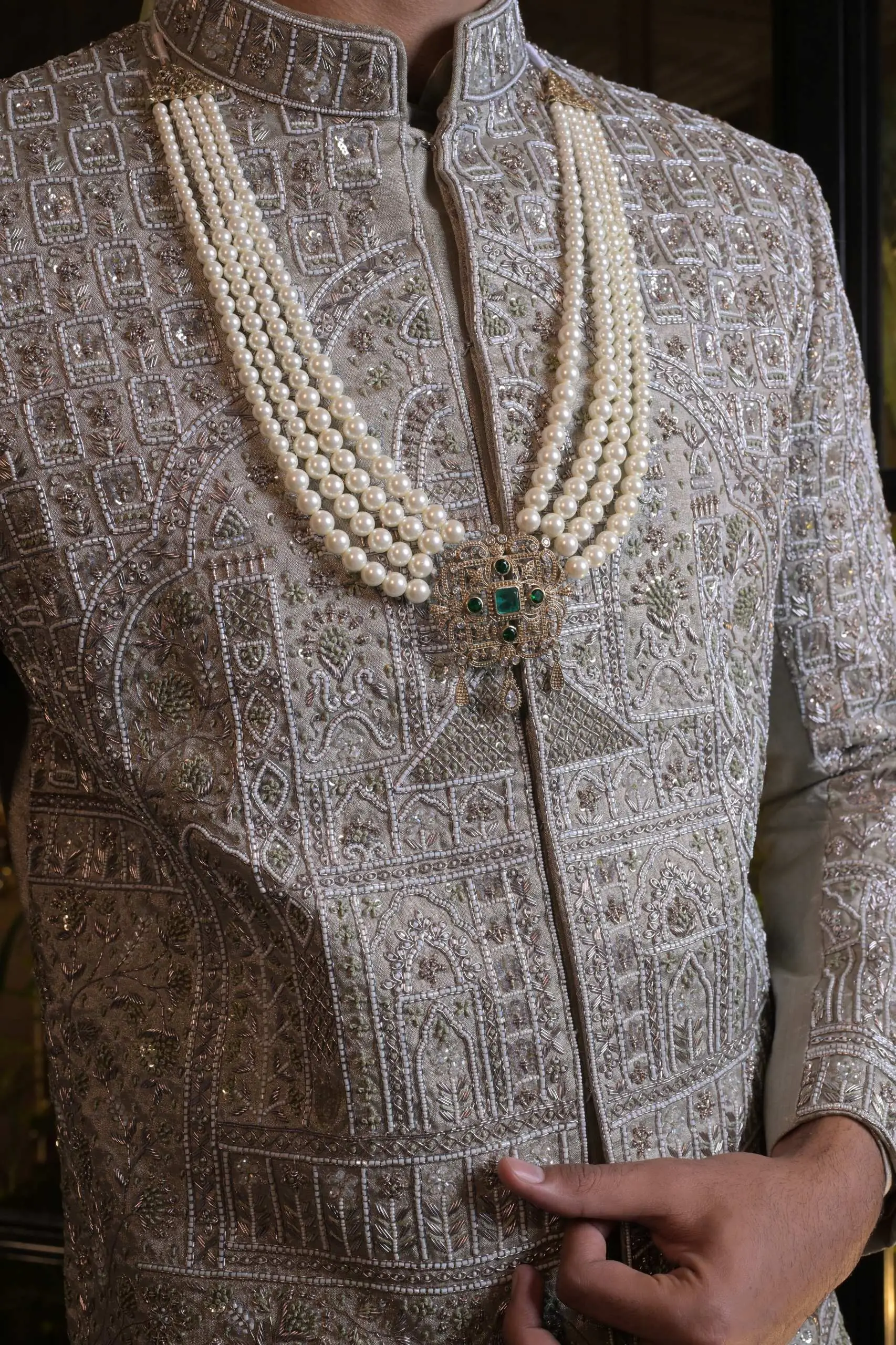 A model in a blush embroidered sherwani